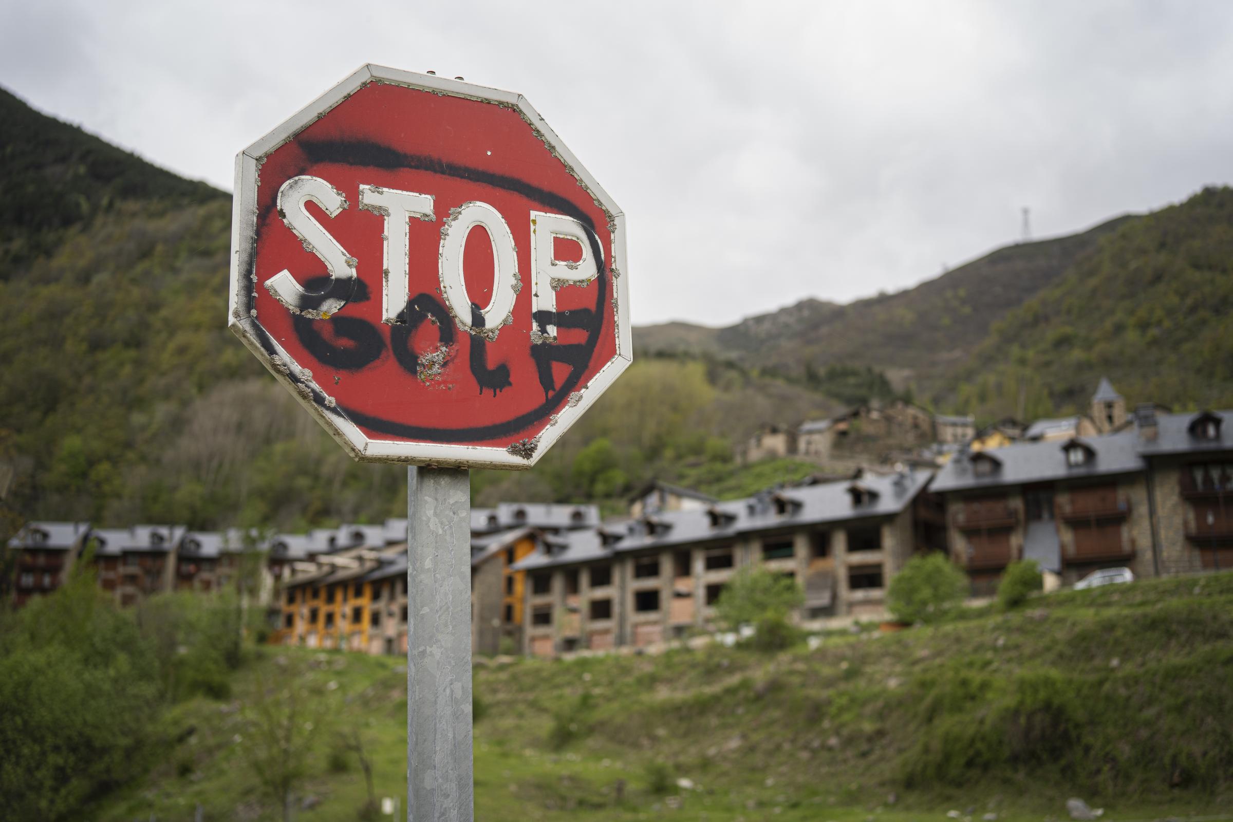  A STOP sign at the entrance to Espui where a villager has added &quot;golf&quot; in...