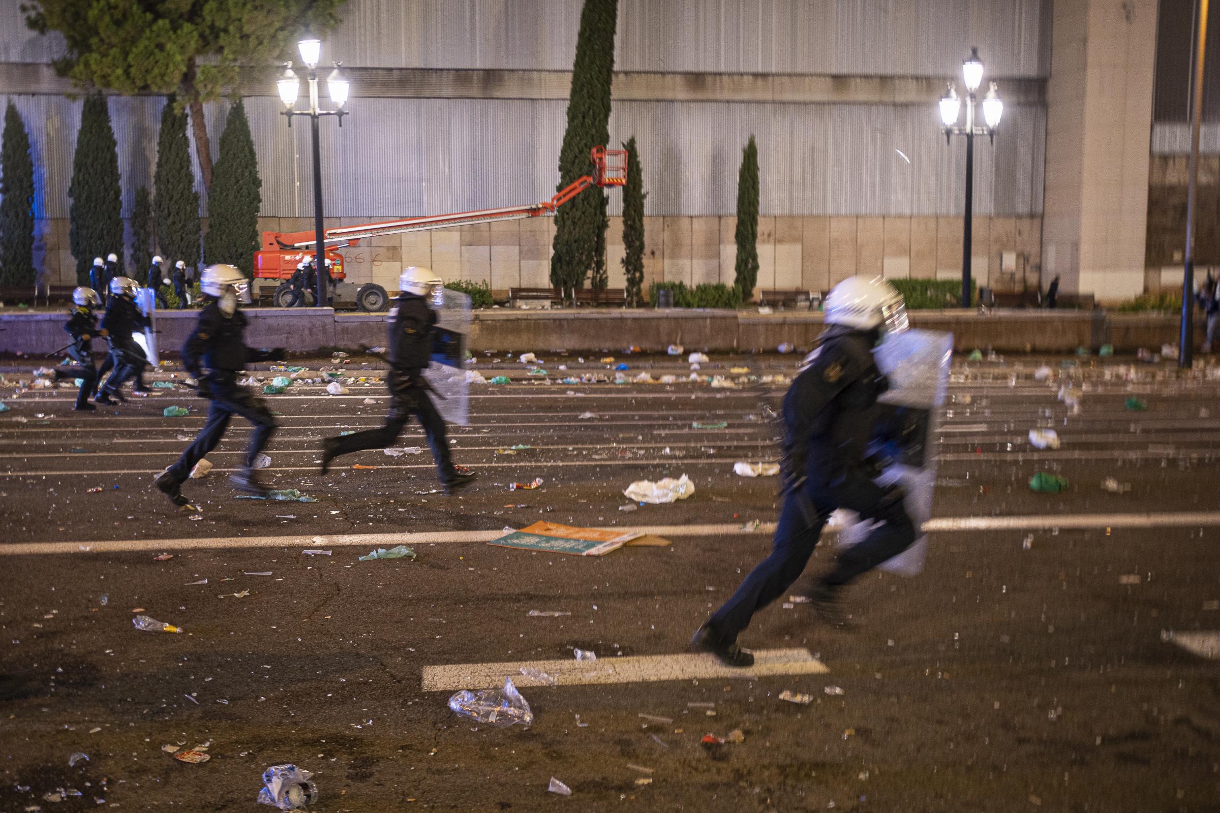 A group of UREP anti-riot police officers run along the Reina Maria Cristina avenue in Barcelona...