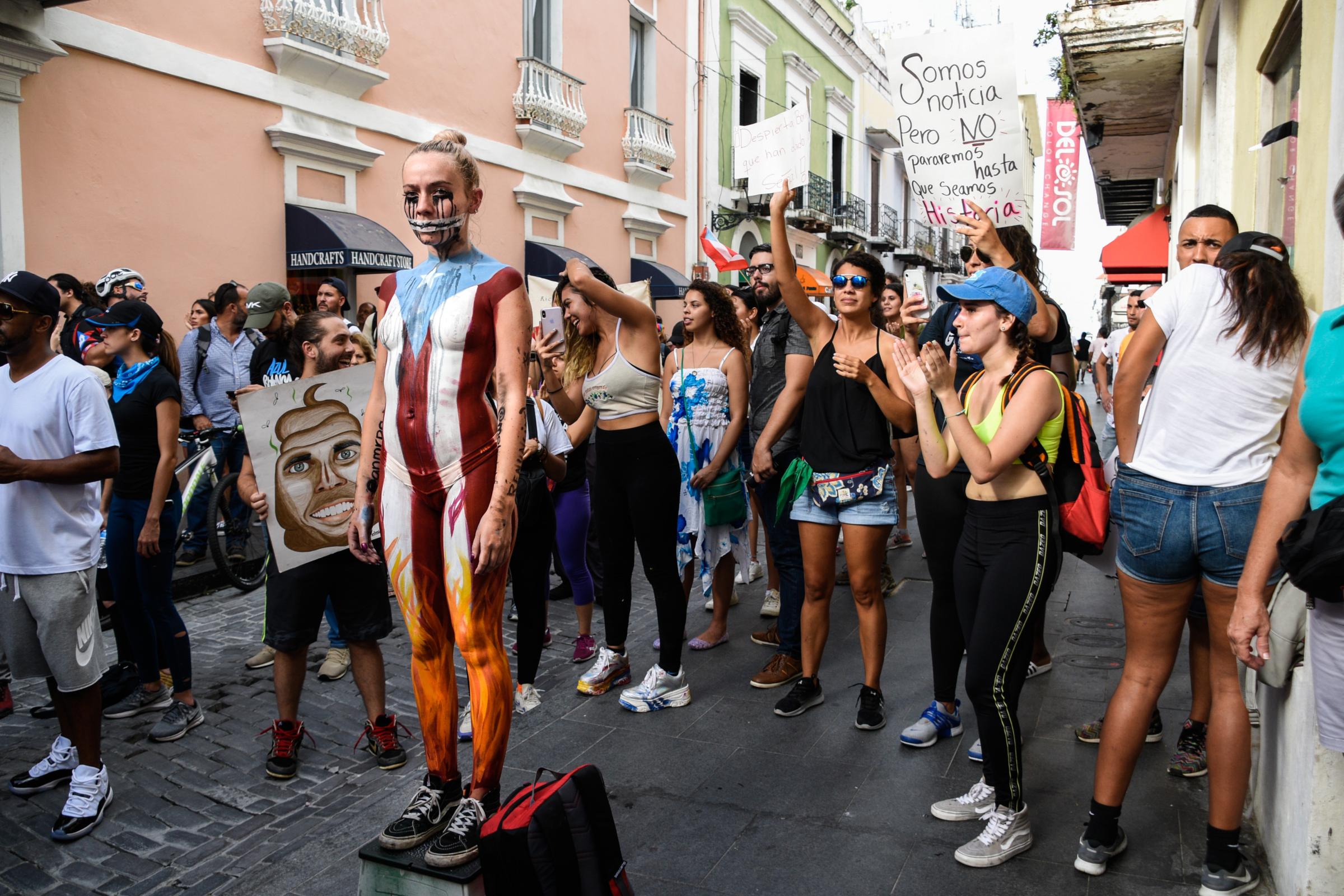 #RickyRenuncia: Reuters, Bloomberg, NYT - Demonstrators shout slogans and sing chants during a...