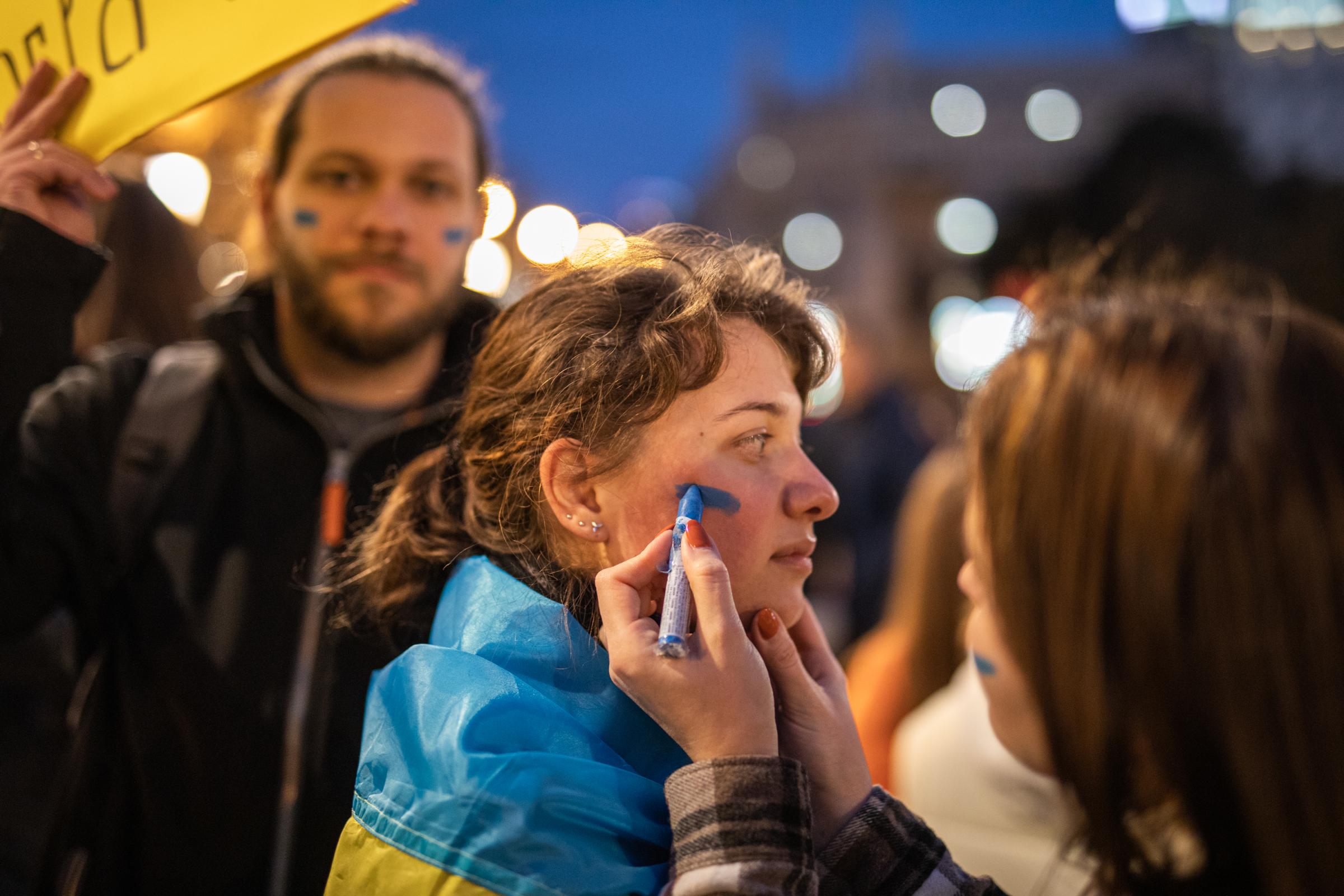 Protestors In Spain Rally For Ukraine After Russian Invasion - BARCELONA, SPAIN - FEBRUARY 26: A girl paints her...