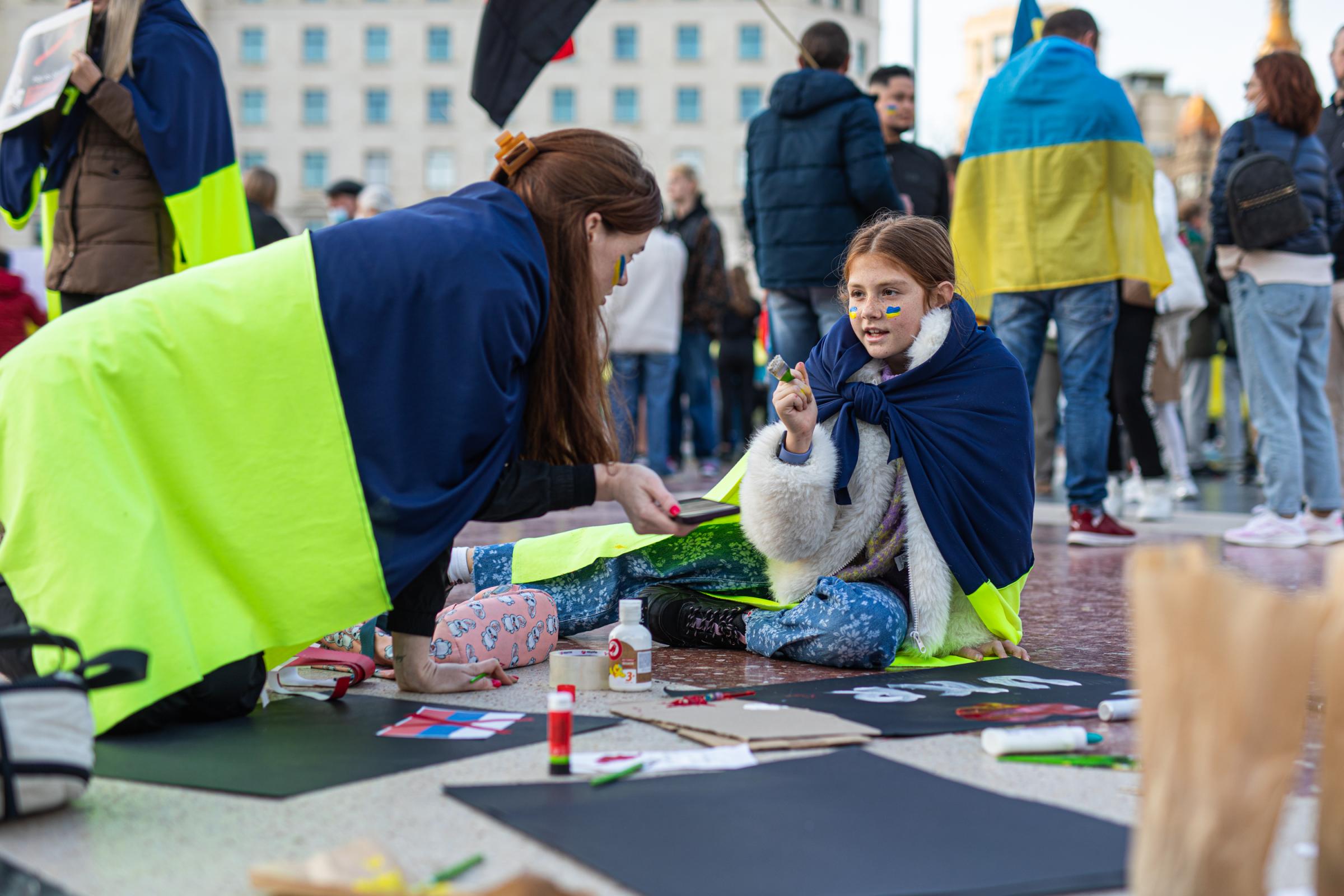 Protestors In Spain Rally For Ukraine After Russian Invasion - BARCELONA, SPAIN - FEBRUARY 27: Two young men paint and...