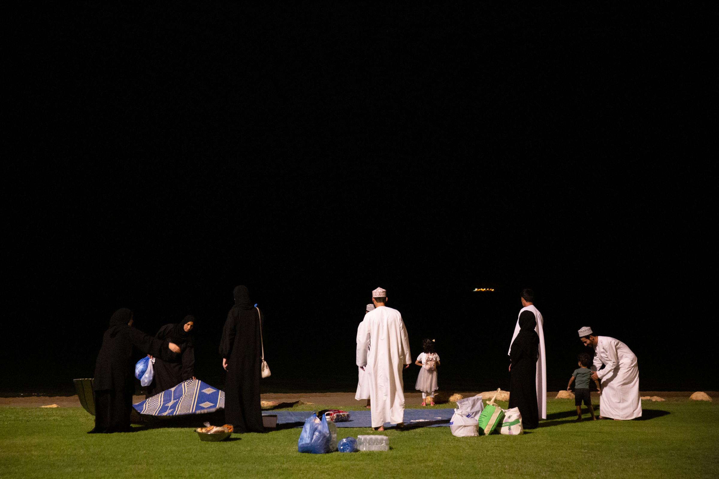 Young Oman - Oman, Muscat. Family pic-nic on the promenade, in the...