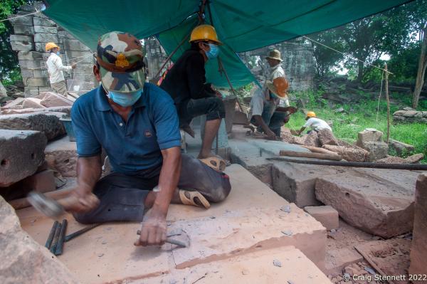 BANTEAY CHHMAR. CAMBODIA-MAY 22: Khmer stone masons at work on the laterite stones at the Banteay Chhmar Temple, Banteay Meanchey, Cambodia on May 22, 2012. Stone masons and architechts have spent the last 3 years painstakingly dismantling and rebuilding just this 20 metre section of the temple alone at the ruins of the Khmer Temple complex. Banteay Chhmar, meaning 'The Citadel of the Cats' was built by Khmer King Jayavarman 7th (1181-1219) in the 12th Century. According to the UNESCO world heritage centre the temple is a unique complex of the Angkorian period of structural style. However, the temple complex through the effects of time and weather is slowly crumbling. Teams of Cambodian archeologists, stone masons with the support of the Global Heritage Fund and Cambodian government are mounting a rescue mission in order to stem the temple's continued collapse and reclamation from the surrounding jungle. (Photo by Craig Stennett/Getty Images)