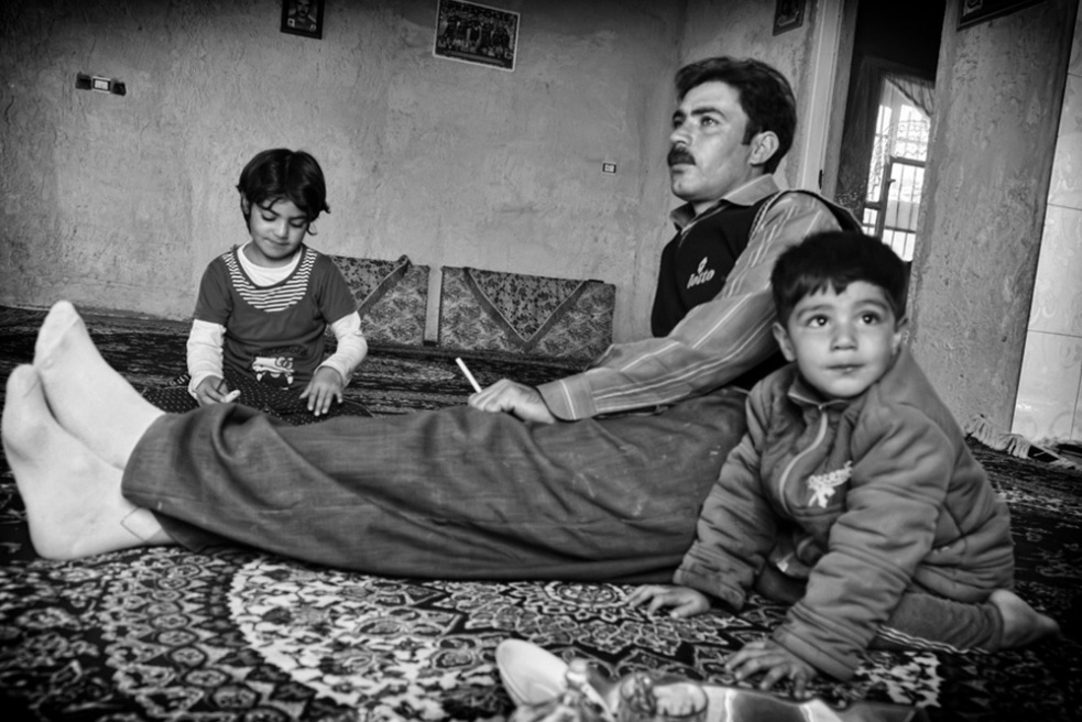 Aliâ€™s family, watching TV. Al...Mohaddeseh, doing her homework.