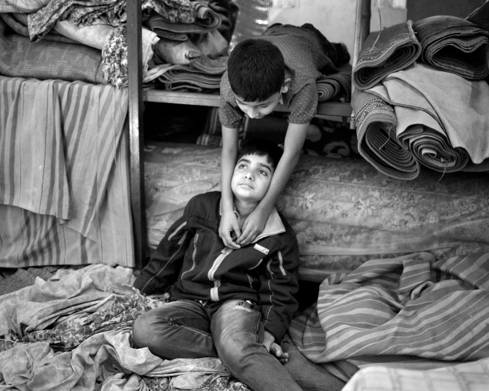 Children take rest in a storage...i Dalan during Friday prayers. 