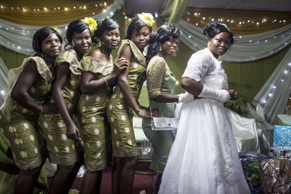 Bride Temitope Caulker poses wi... the decor of the wedding hall.