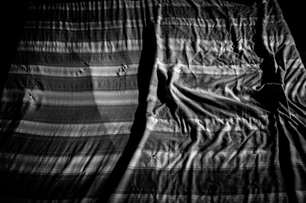 Little Left to Lose - Î‘ sheet of a hotel bed  at central Athens. There are...