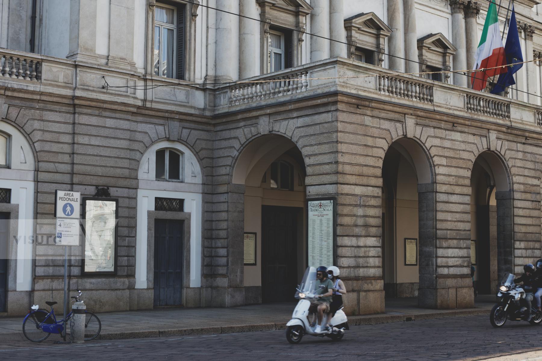 Purchase People passing in front of La Scala on a Vespa by Laura Larmo