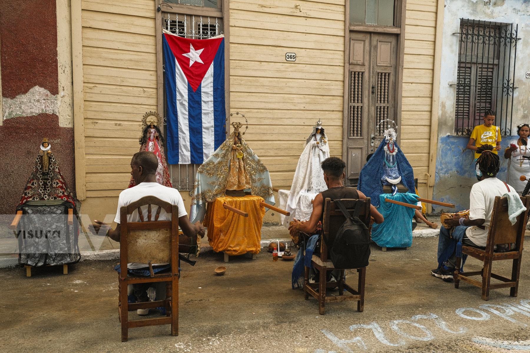 Purchase Bataleros play batá drums during the celebation of Cabildo of Yemaya in the town of Regla. by Dany del Pino Rodríguez
