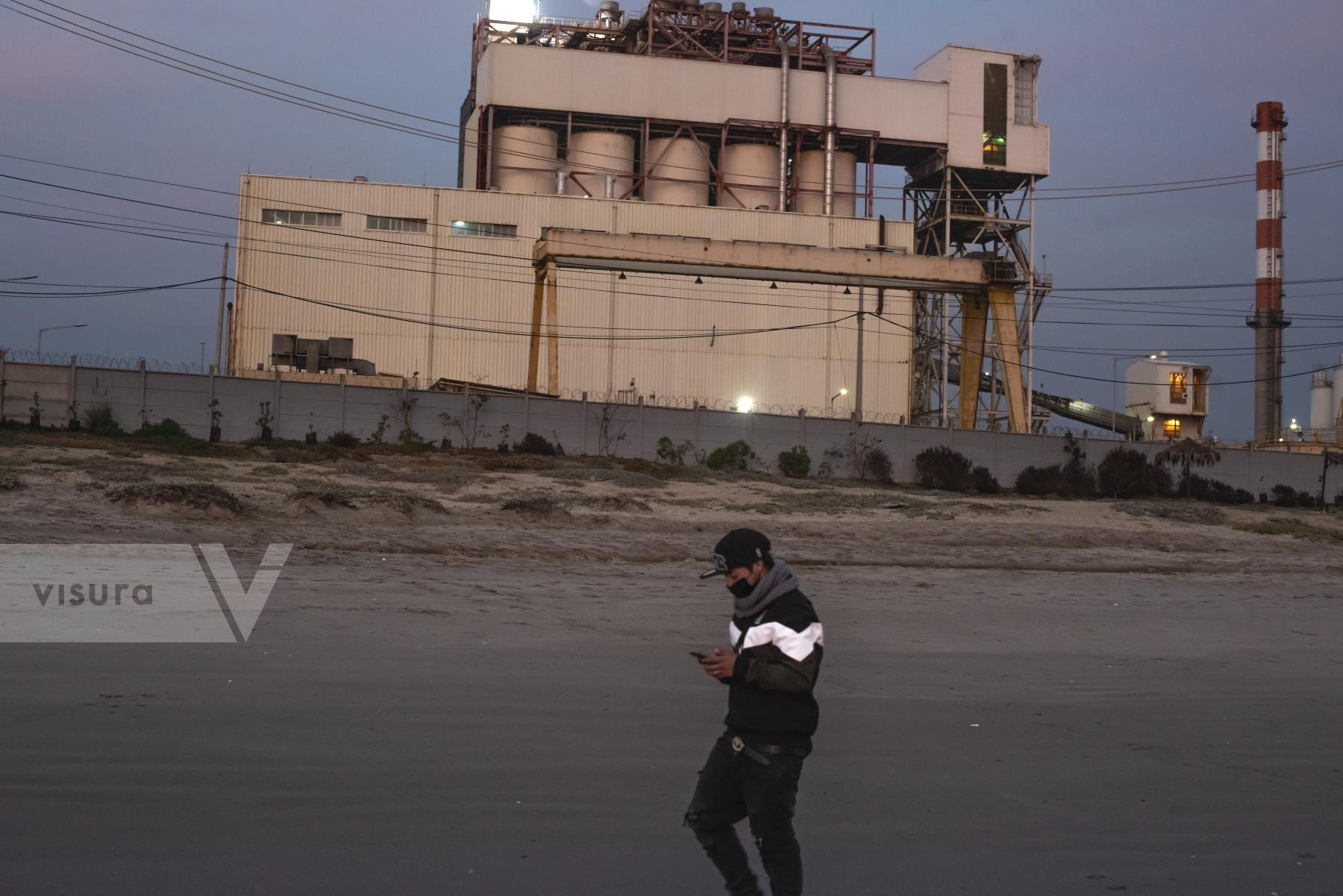 Purchase A teenager walks past the AES Geners thermoelectric plant by cristobal Venegas