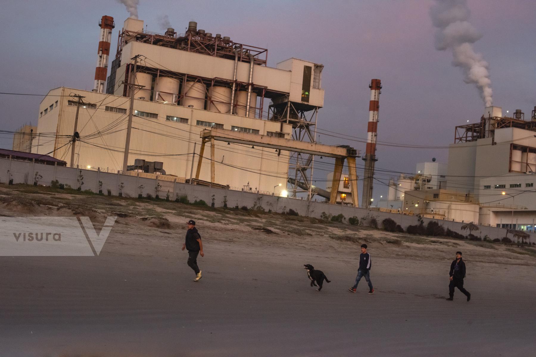 Purchase Children play with a dog near the AES Geners thermoelectric plan by cristobal Venegas