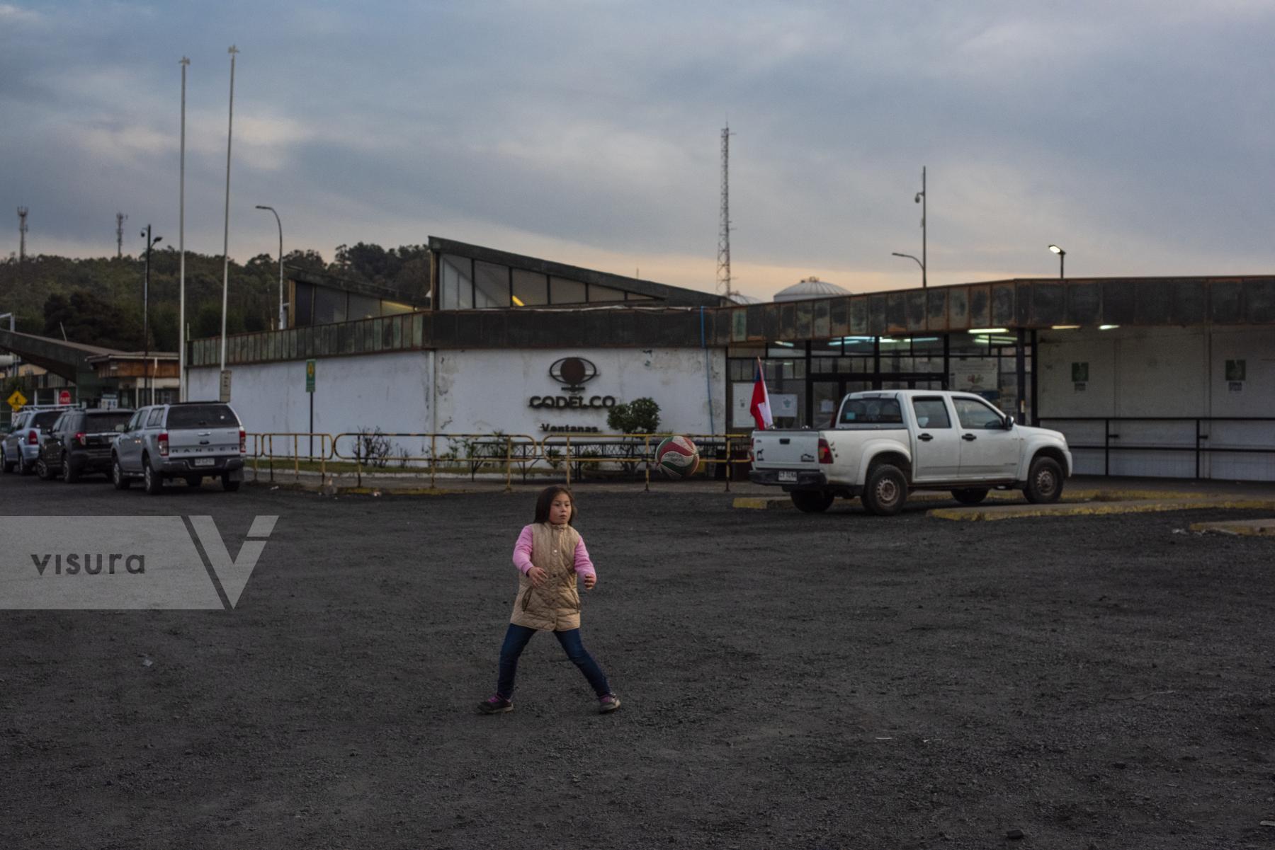 Purchase A girl plays ball at the entrance of the Codelco refinery factory. by cristobal Venegas