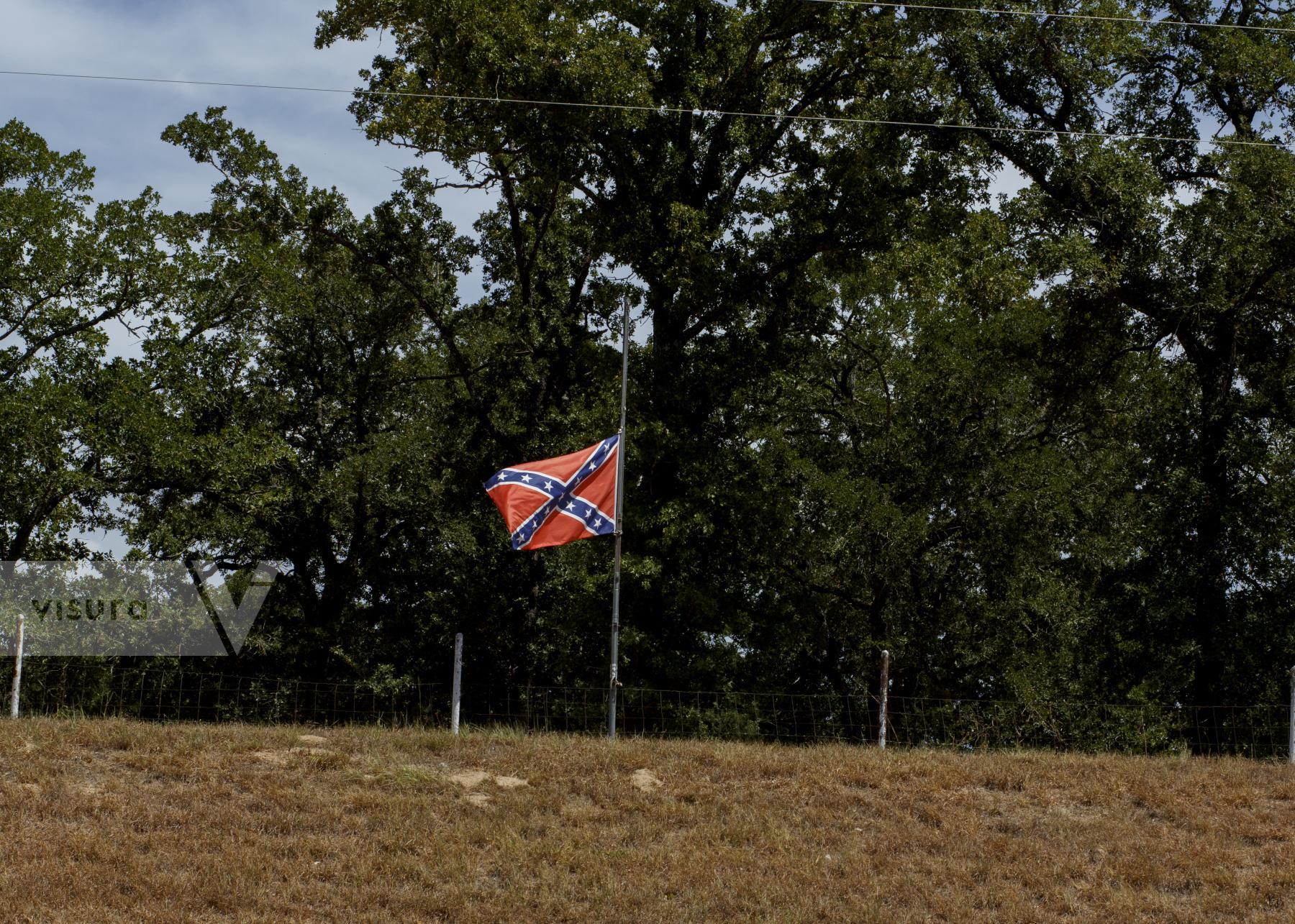 Purchase Confederate flag flies on a hill by Texas state highway 77 near Rockdale Texas by Jaime R. Carrero